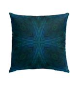Outdoor pillow with rainbow design placed in a garden setting, enhancing outdoor decor.
